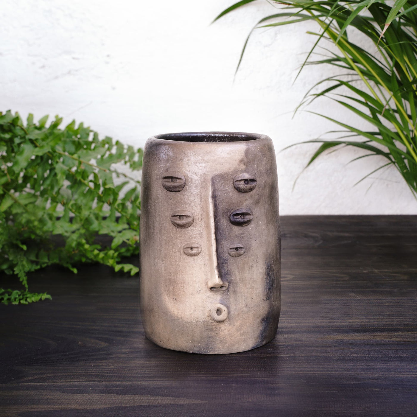 Tall, boho-style vase, showcasing its handcrafted design and elegant shape