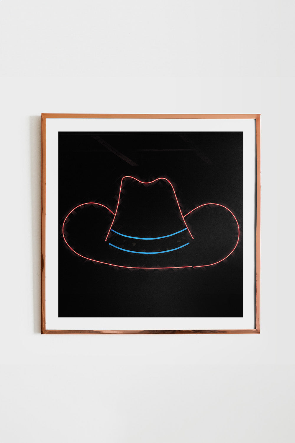 Square art print of 'Neon Cowboy Hat', featuring a bold black background with a simple thin outline of a cowboy hat.