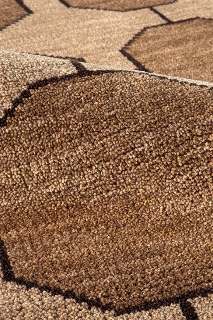 Close-up of a textured brown runner rug with geometric patterns