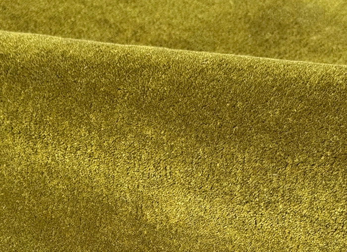 Close-up of olive green wool rug tufted surface