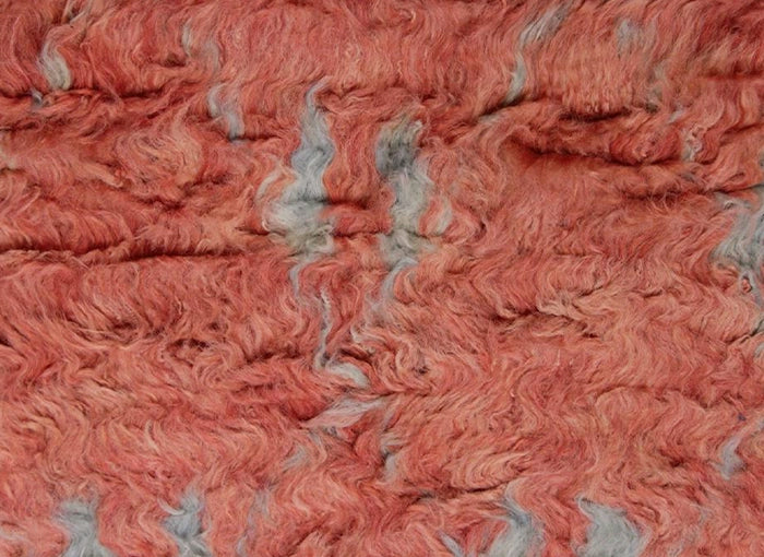 Close-up of red orange and gray moroccan shag rug texture