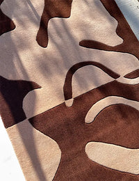 Close-up of brown abstract rug texture, cozy handmade wool rug for modern interiors