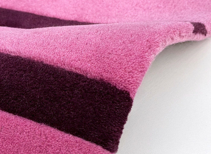 Close-up of a pink and purple striped wool rug