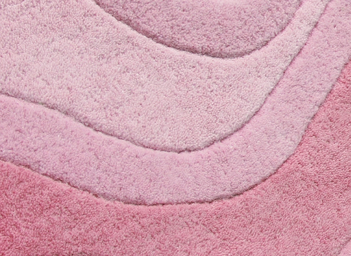 Close-up of a pink textured rug with layers