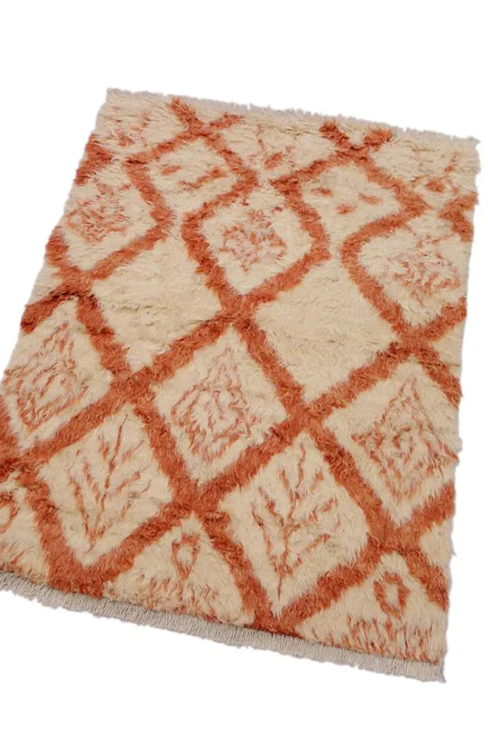 handmade white shag rug with a warm terracotta pattern, adding a modern touch