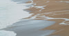A receding tide leaving nested lines on sand — the Rolling Tides reference