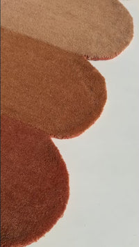 video showcasing texture colors and design of tiers scalloped gold and brown wool area rug