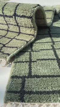 green hand-knotted wool rug