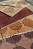 video of brown geometric rugs stacked on top of one another