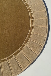 video of a gold rug with arch and tile design