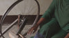 video of an artisan spinning raw wool on a wheel