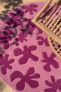 Round pink floral rug styled in living room, perfect round rug under round table