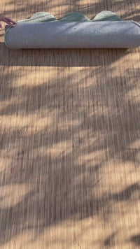 3x5 hand-tufted modern wool rug rolled on wood floor, abstract green area rug