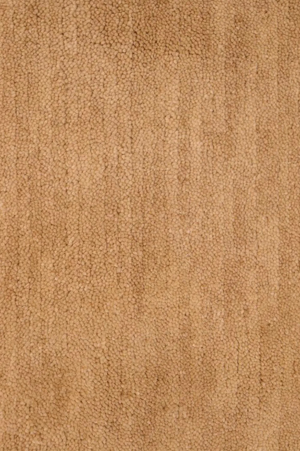 Close-up of natural tan hand-knotted wool rug surface, showing fine artisanal texture perfect for luxury area rugs and organic modern decor