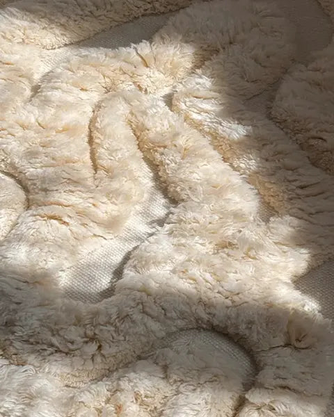 Close-up of textured beige rug with a soft, plush surface.