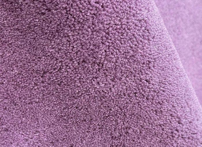 close up of purple tufted rug