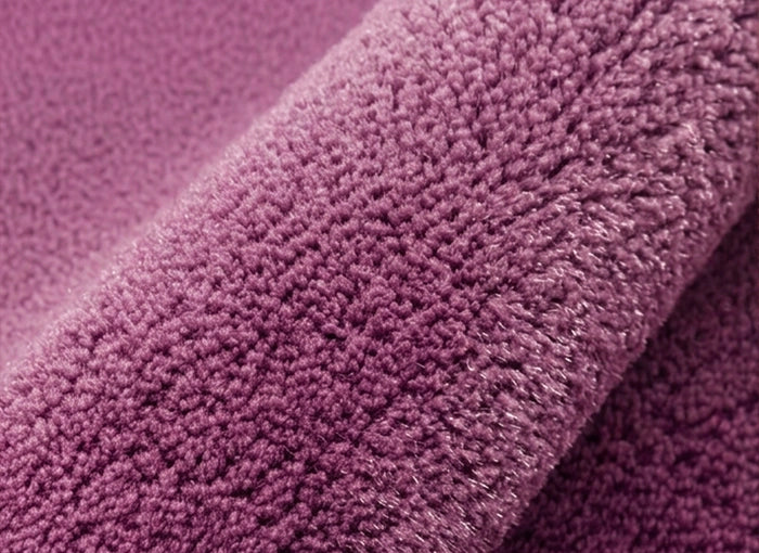 Close-up of a textured purple rug surface