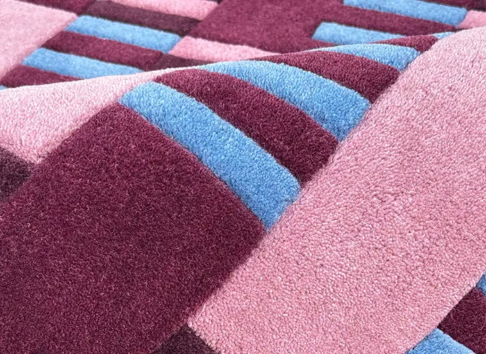 Close-up of a textured rug with purple and blue stripes