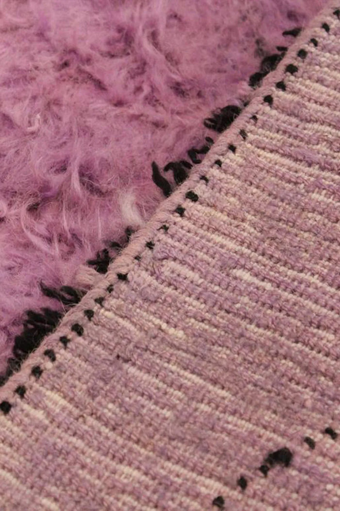 Backside view of hand-knotted lavender wool shag rug showing secure cotton foundation, great for 8x10 purple area rugs and luxury nursery rugs