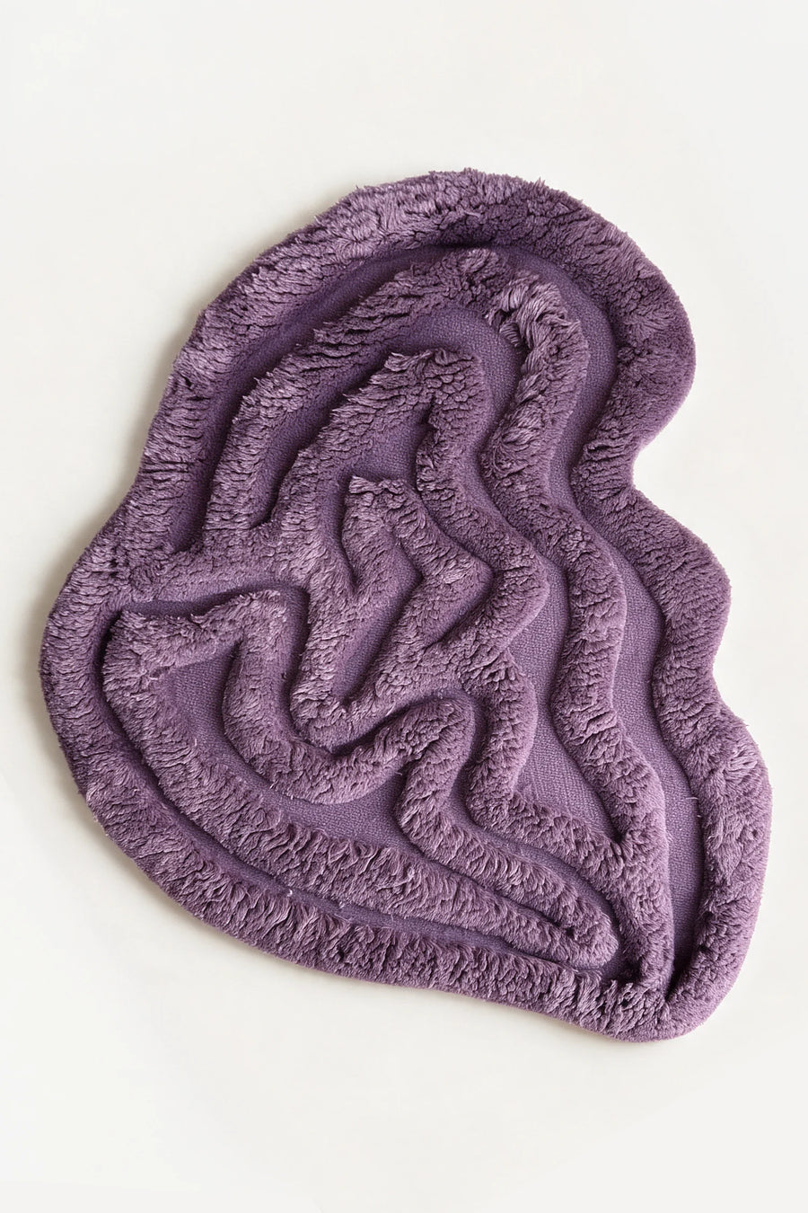 a rolling tides shag hand-knotted wool rug in lavender, shown flat from above