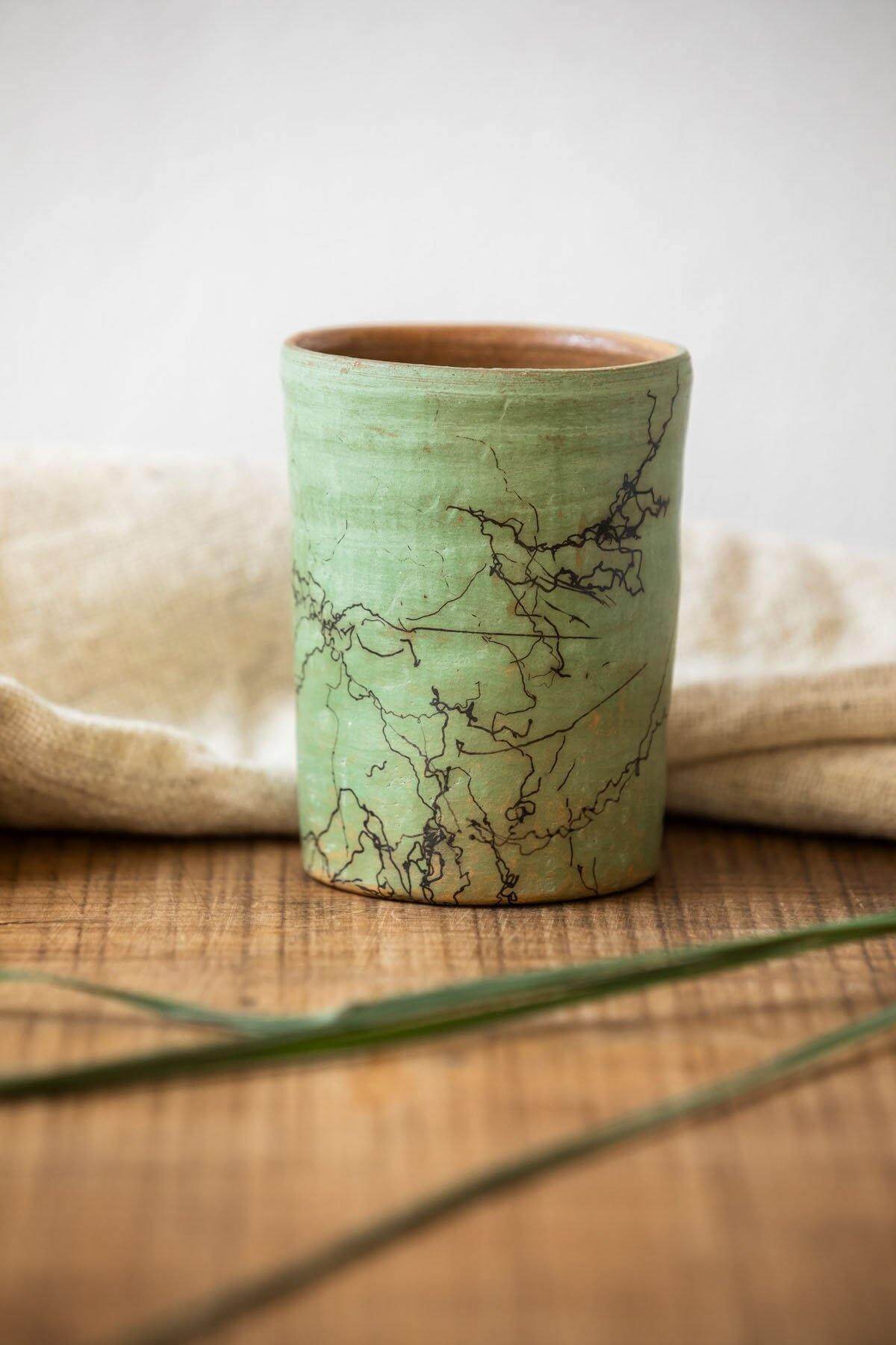 Artistic Raku Ceramic Mug in Sage color, perfect as a decorative accent