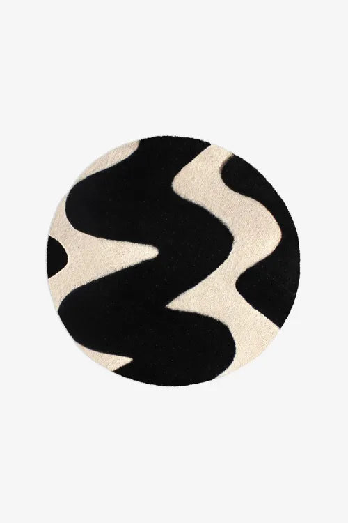 Round rug with black and beige wavy pattern on a white background