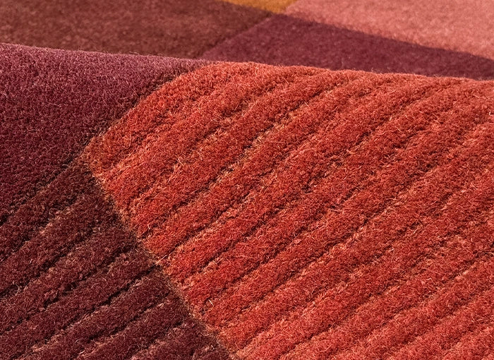 Close-up of textured brown carpet with different patterns