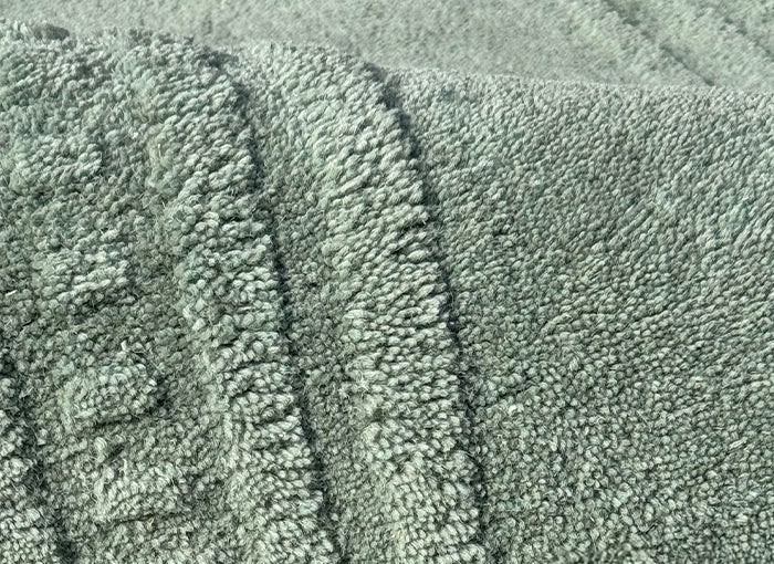 Close-up of sage green wool rug