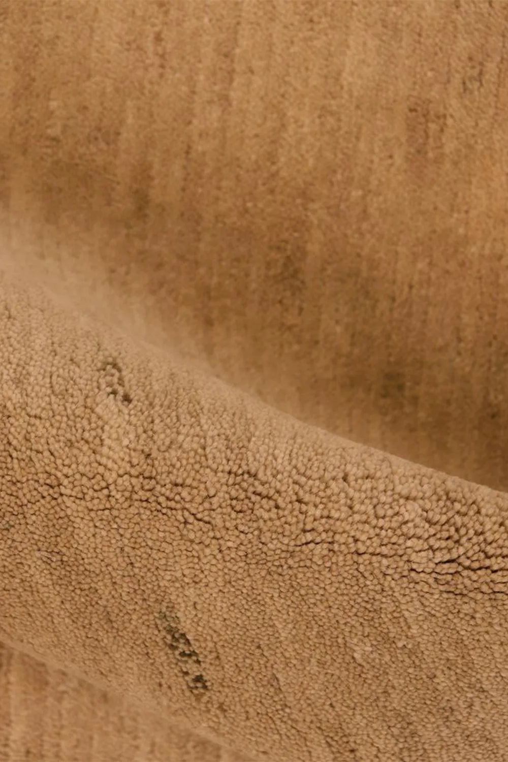 Close-up of hand-knotted tan wool rug showing detailed organic weave, perfect for custom modern rugs and Japandi minimalist homes