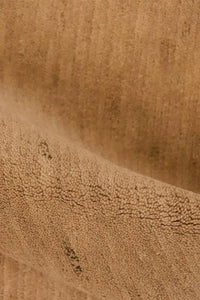 Close-up of hand-knotted tan wool rug showing detailed organic weave, perfect for custom modern rugs and Japandi minimalist homes