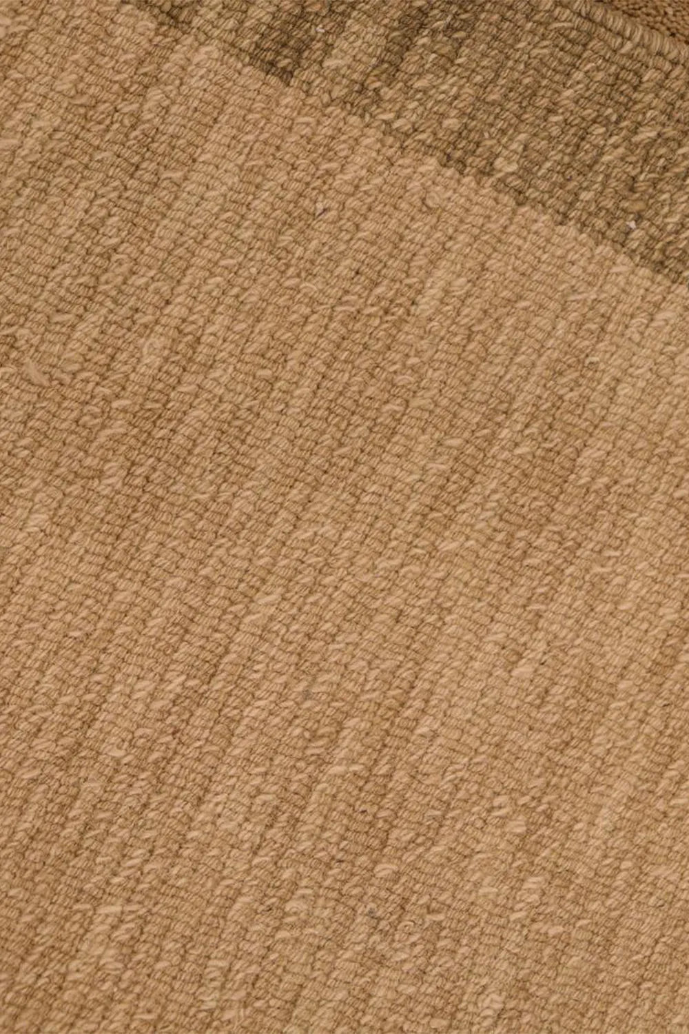 Handmade wool rug featuring soft tan tones and subtle geometric border, perfect for modern luxury living spaces and neutral interiors