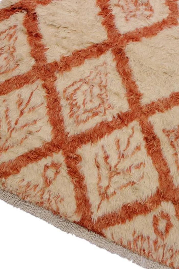 Angled view of cream and burnt orange shag rug showing plush texture and organic modern style, ideal for large living rooms or 9x12 spaces