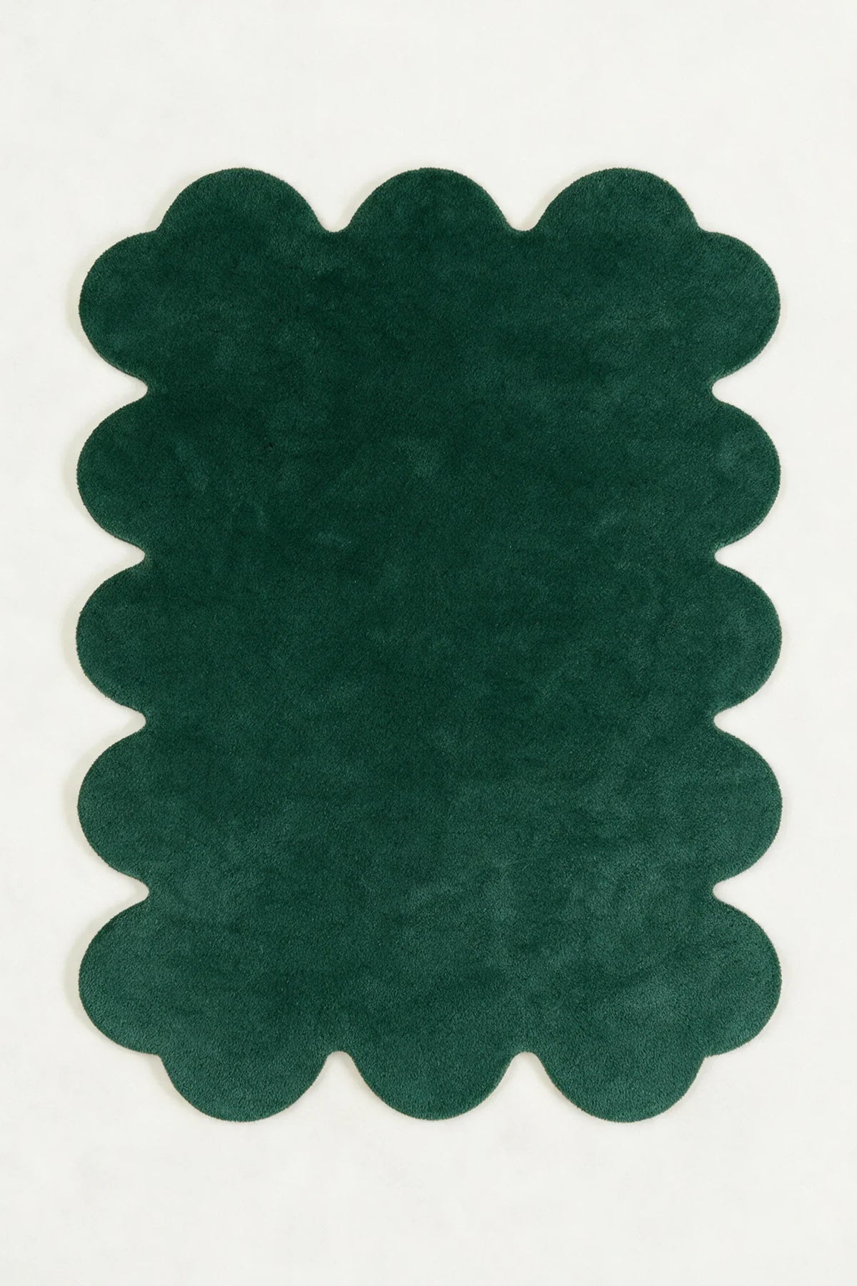 a solid sculpted edge hand-tufted wool rug in pine, shown flat from above