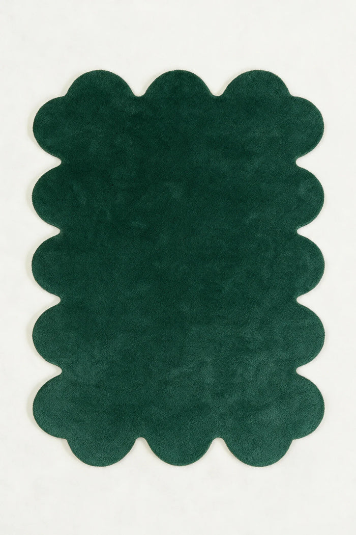 a solid sculpted edge hand-tufted wool rug in pine, shown flat from above