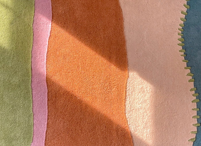 Close-up of a textured rug with multicolored stripes.