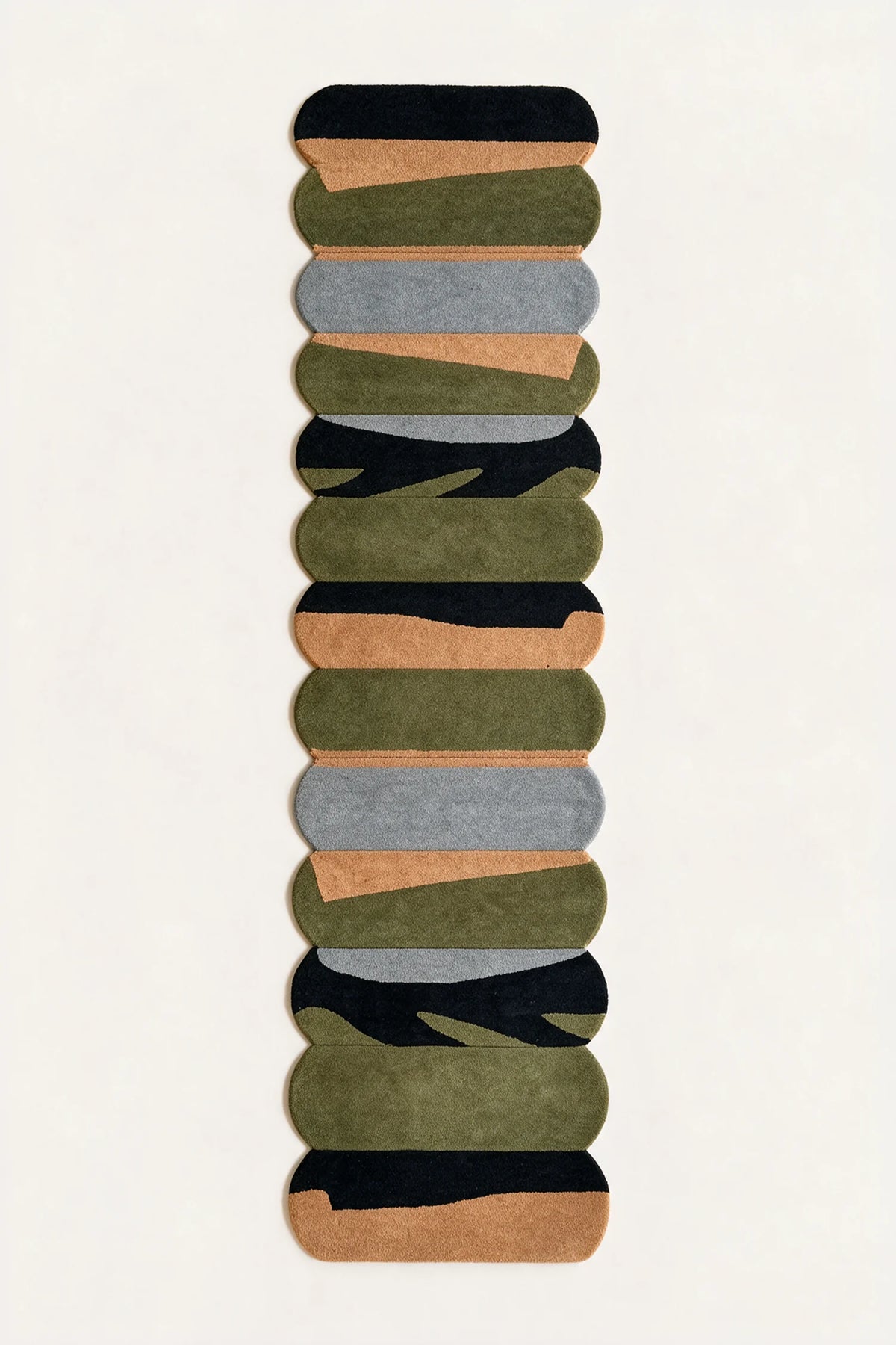 a temple steps hand-tufted wool runner in black, pewter, ochre and army, shown flat from above