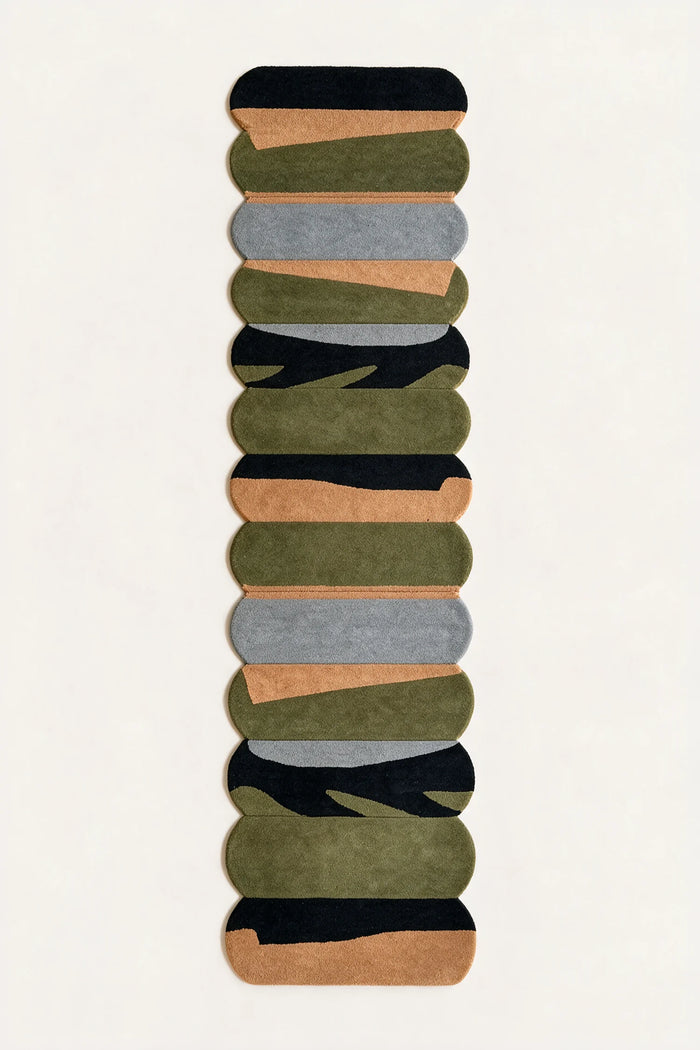 a temple steps hand-tufted wool runner in black, pewter, ochre and army, shown flat from above