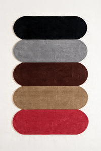 a tiers hand-tufted wool rug in black, gray, brown, taupe and red, shown flat from above