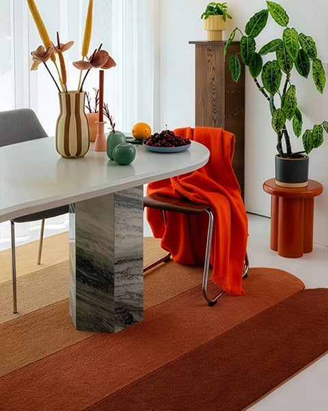 gold irregular shaped rug in a modern dining room