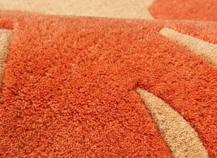 Close-up of a textured orange and beige rug