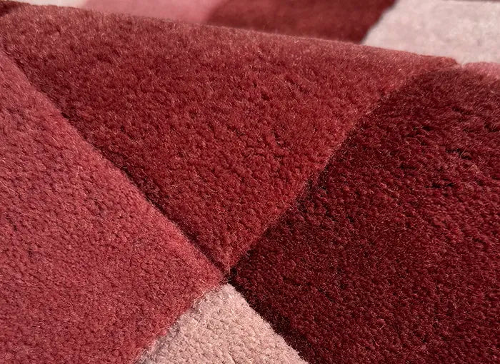 Close-up of a textured red and pink checkered rug