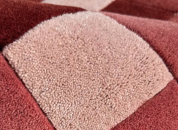 Close-up of a textured rug with geometric pattern