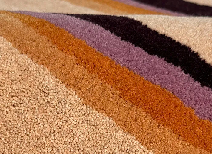 Close-up of a textured rug with multicolored stripes.
