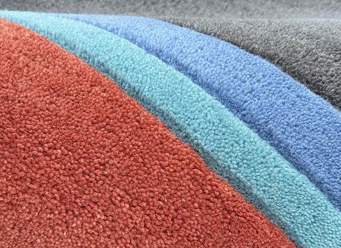 Close-up of textured wool rug in various colors.