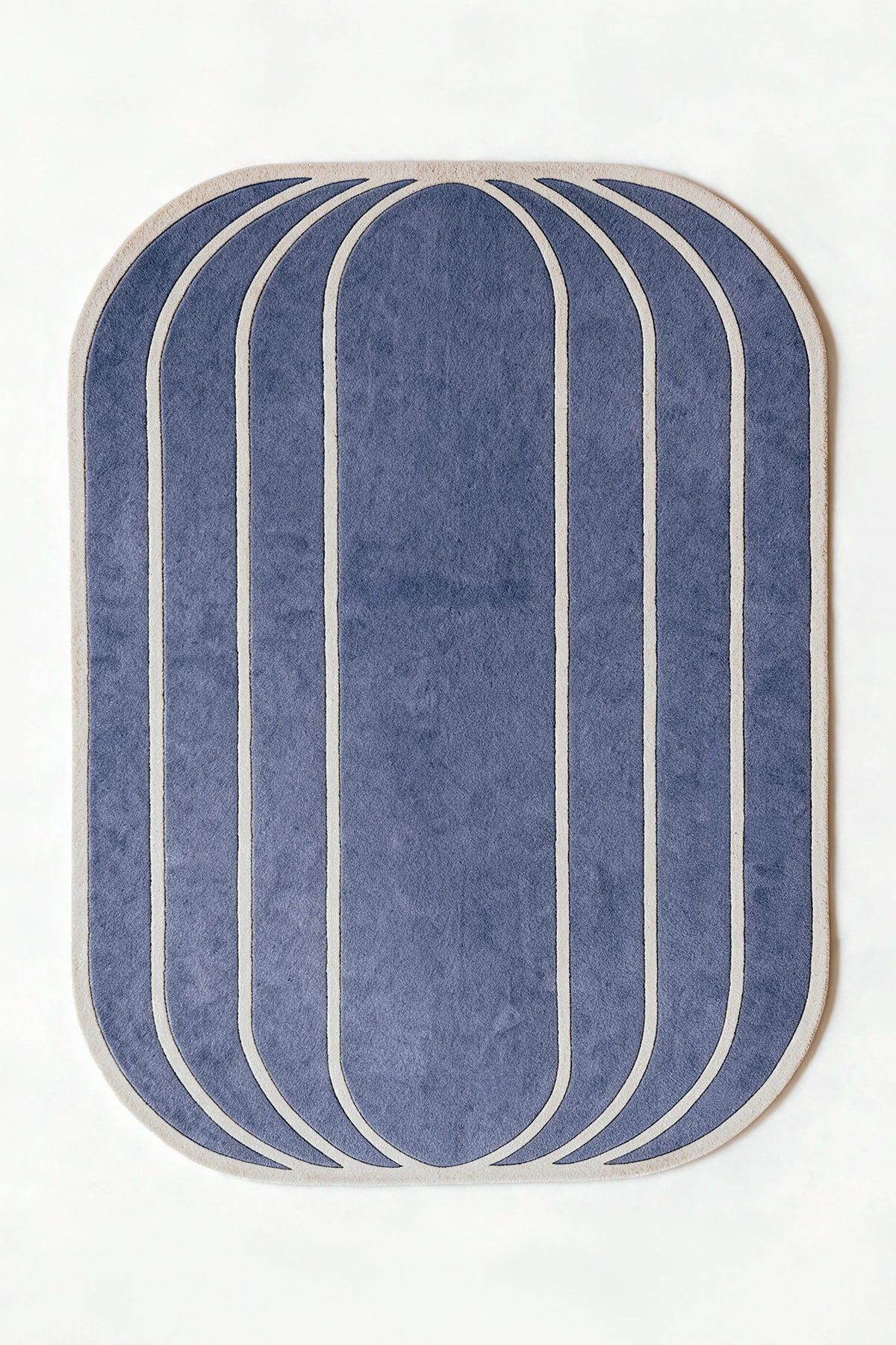a vault hand-tufted wool rug in dusty blue and oat, shown flat from above