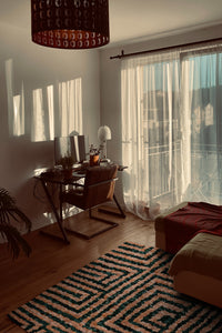Modern striped wool shag rug styled in an airy southwest inspired living room