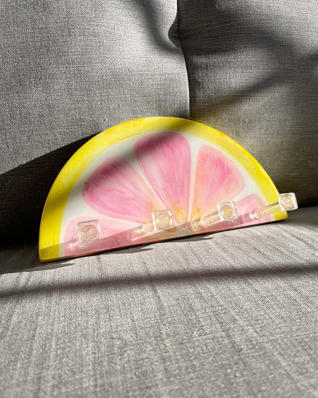 Artistic wooden key holder with vibrant pink grapefruit slice painting and hooks