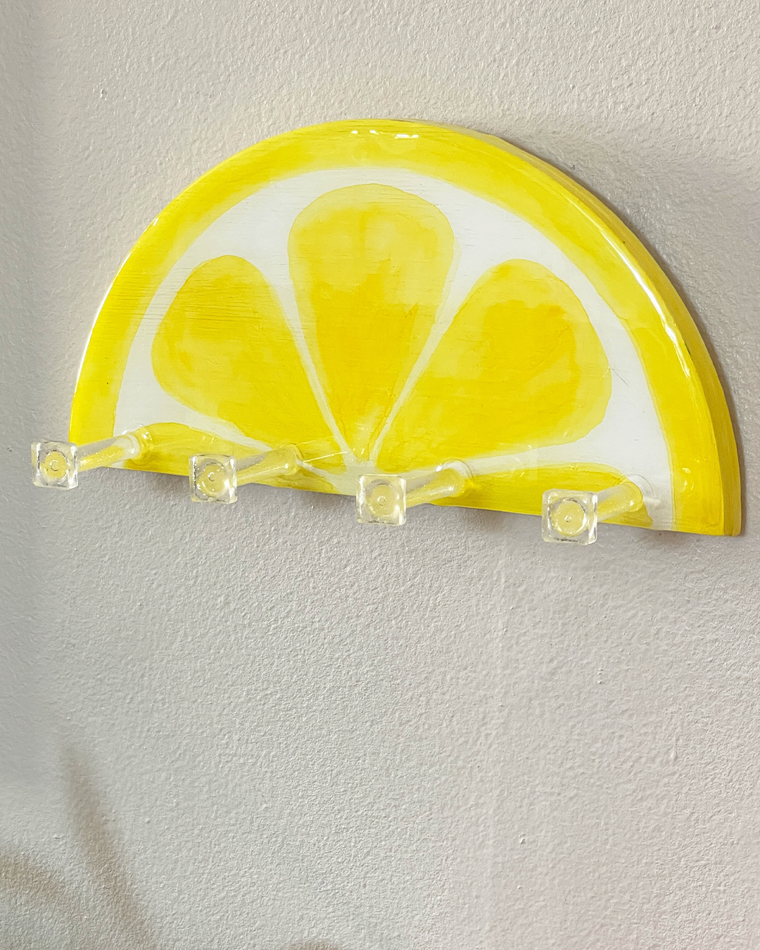 Wooden key holder painted to look like a lemon slice, a unique and patent-pending design for stylish organization.