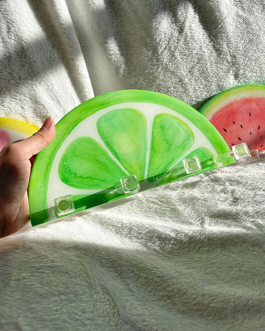 One-of-a-kind lime slice key holder, demonstrating its use for hanging small household items in a creative way