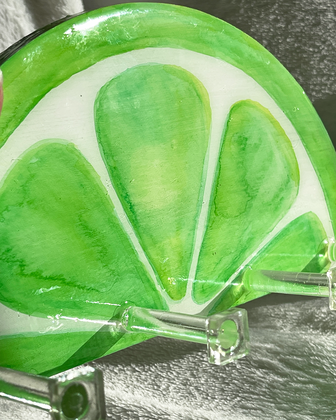 Hand-painted lime slice key holder, combining vibrant green hues and realistic citrus design on a wooden base
